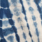 A close-up of blue and white tie-dye pattern using indigo plant dyes on our 100% organic cotton crewneck sweatshirt.