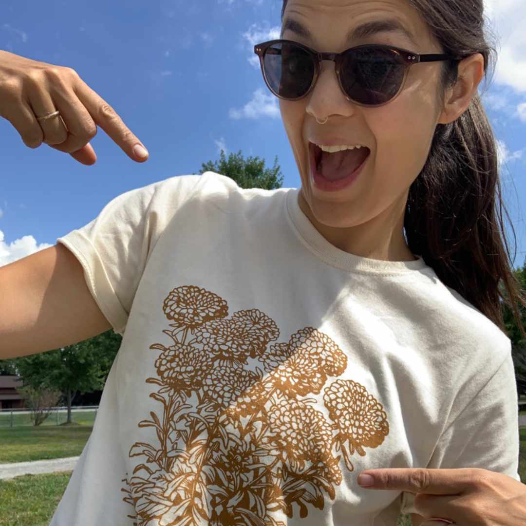 Rare Breed Organic Apparel's Marigold T-shirt featuring a vintage garden design in natural tones of rust and cream. Responsibly made in North America. Available to customers throughout the U.S. and Canada. A great gift for gardeners!